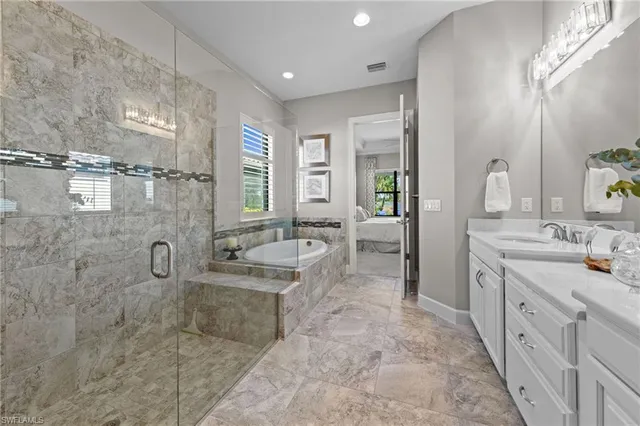 a bathroom with double vanity sinks double vanity tub shower and a mirror