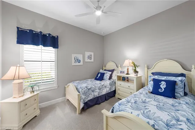 a spacious bedroom with two beds and a window