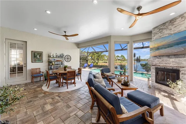 a living room with furniture a fireplace and a dining table