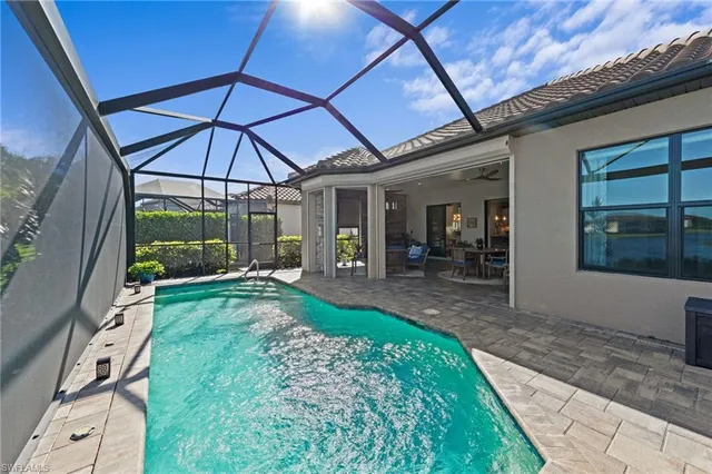 a view of a patio with a table and chairs under an umbrella