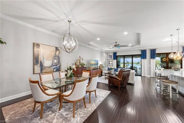 a view of a dining room with furniture wooden floor and a chandelier
