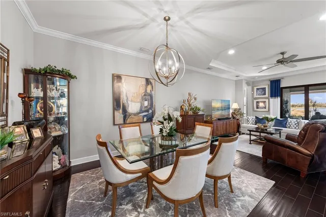 a view of a dining room with furniture a chandelier and wooden floor