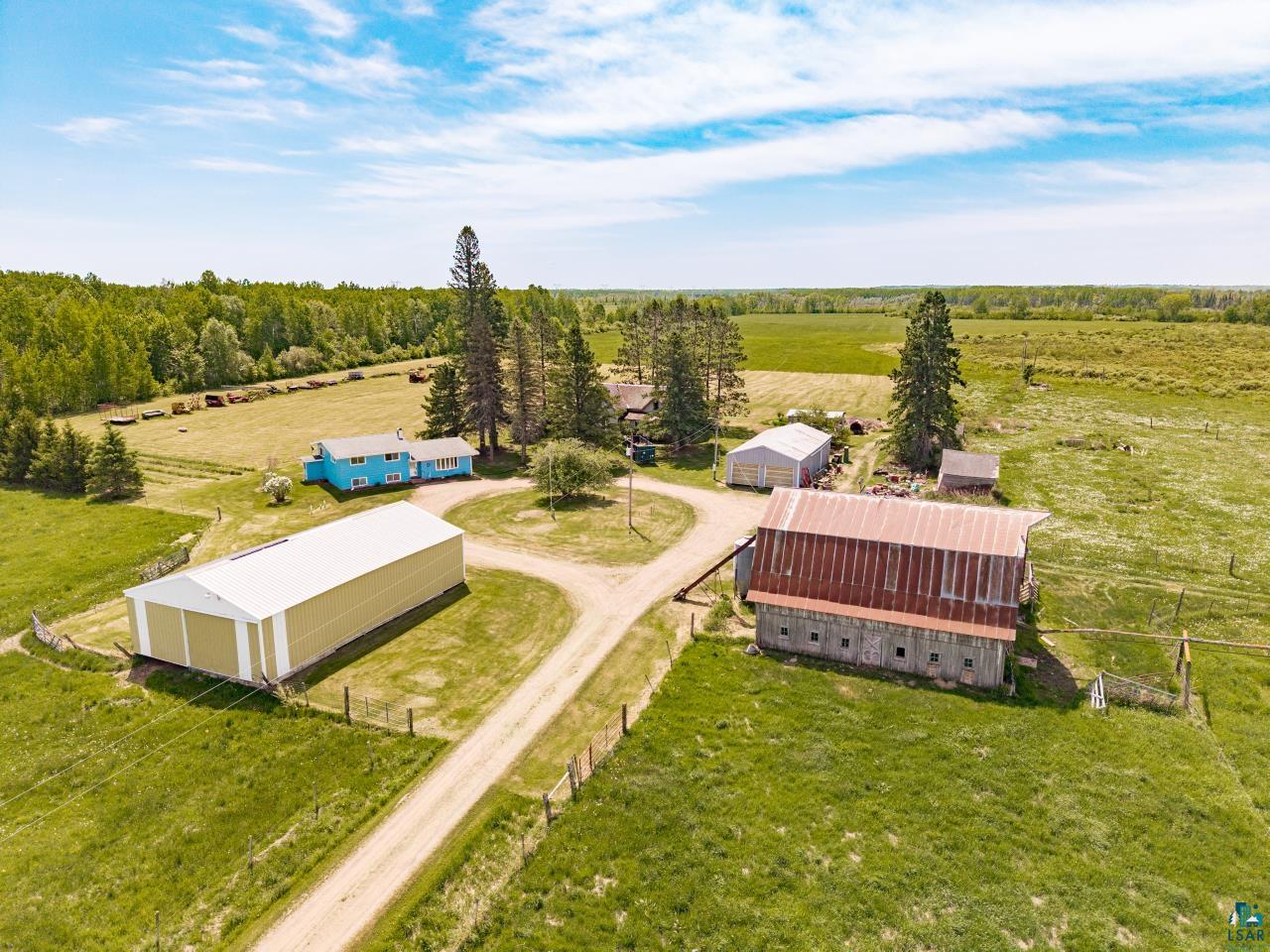 6606 Metso Road Kettle River, MN 55757 - Photo 10 of 84 Expansive rural property featuring a main residence, a large barn, and multiple outbuildings