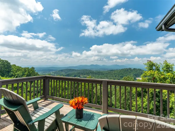 a view of a balcony with two chairs