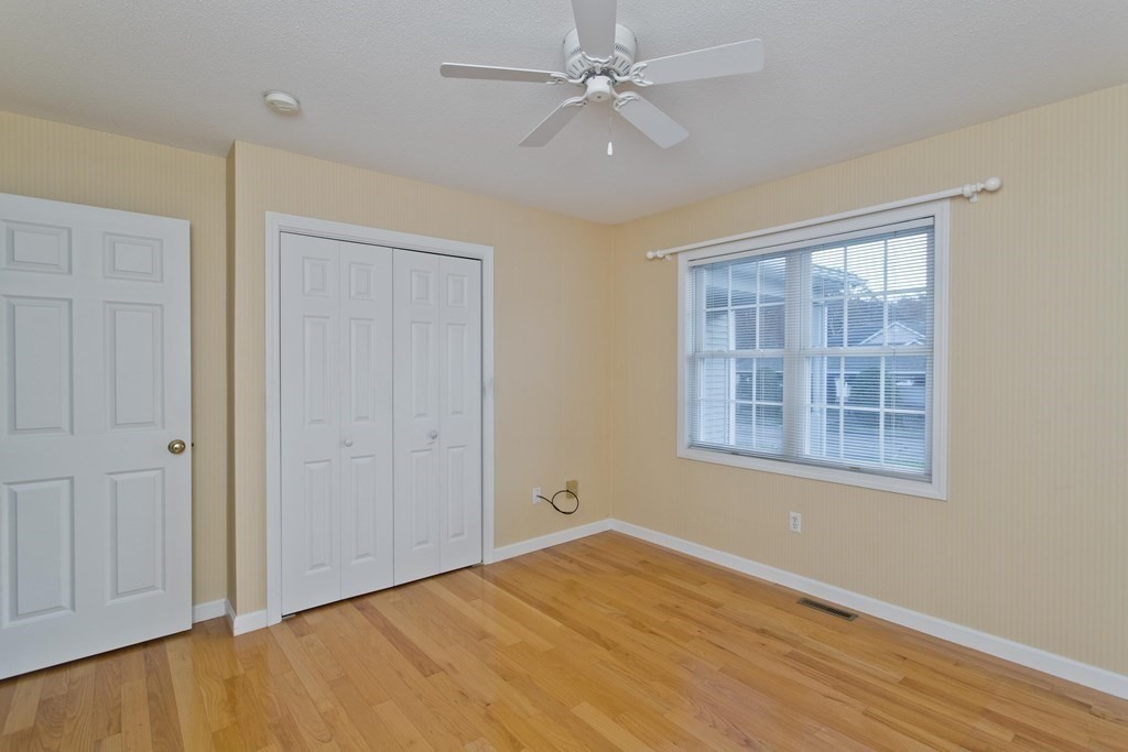 210 Johnson Road, Unit 5 Chicopee, MA 01022 - Photo 12 of 19 a view of an empty room with a window and wooden floor