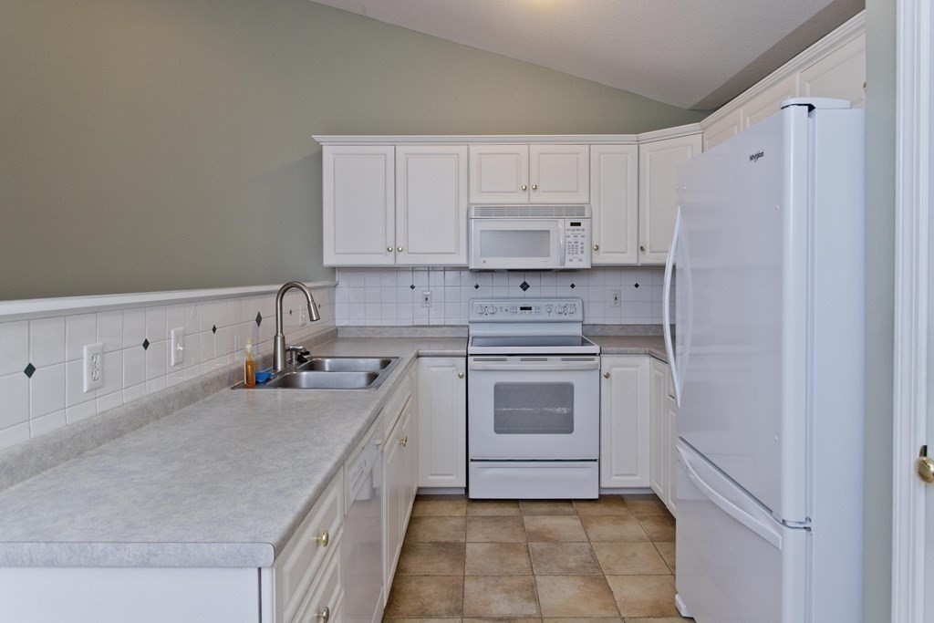 210 Johnson Road, Unit 5 Chicopee, MA 01022 - Photo 5 of 19 a kitchen with a sink stove and cabinets