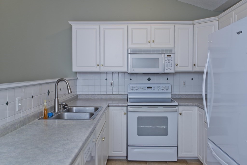 210 Johnson Road, Unit 5 Chicopee, MA 01022 - Photo 6 of 19 a kitchen with cabinets appliances and a sink