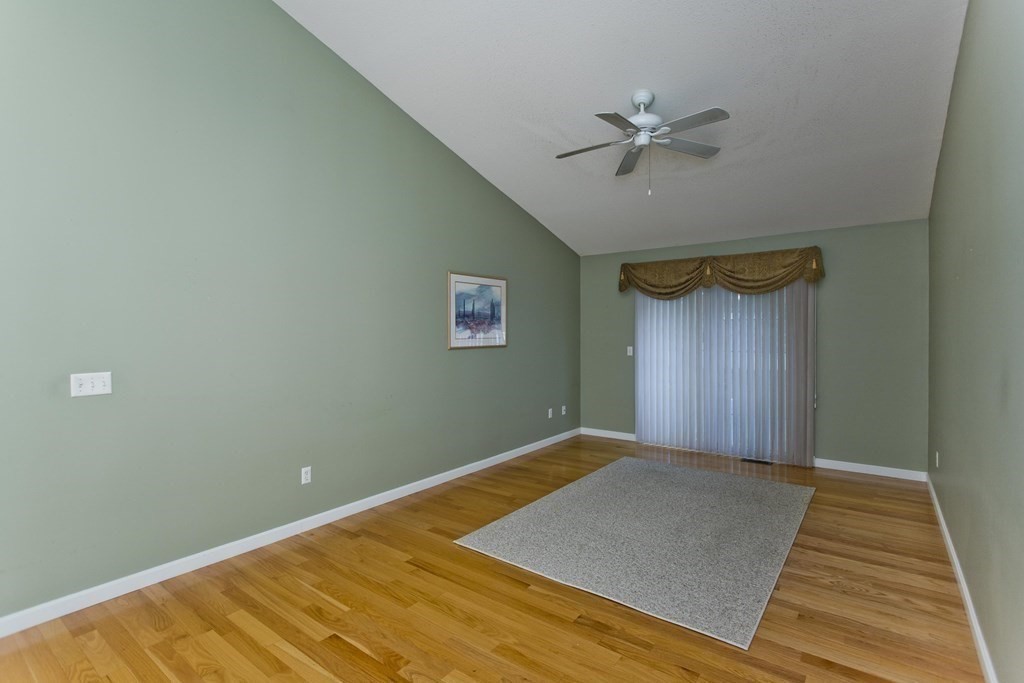 210 Johnson Road, Unit 5 Chicopee, MA 01022 - Photo 8 of 19 a view of a room with a ceiling fan and wooden floor
