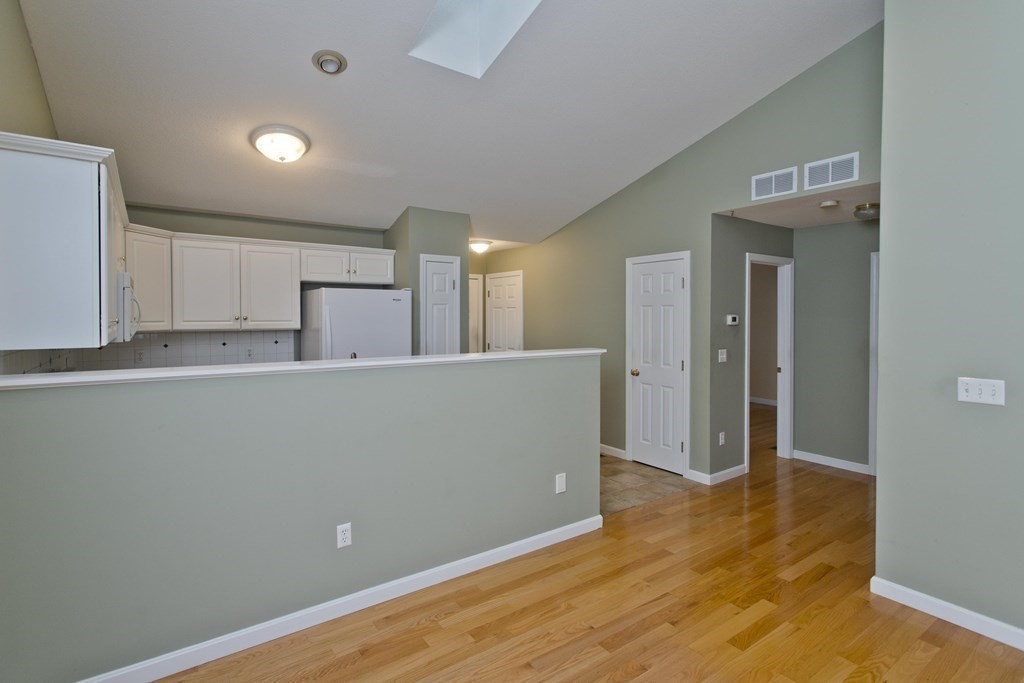 210 Johnson Road, Unit 5 Chicopee, MA 01022 - Photo 9 of 19 a view of a kitchen with wooden floor and a sink