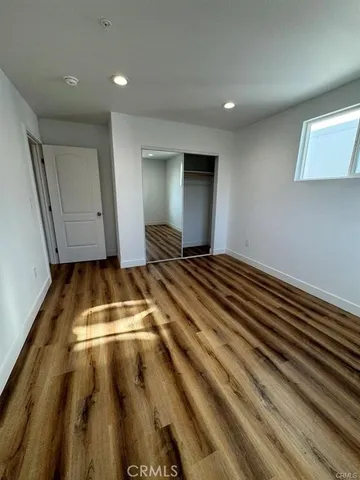 a view of room with wooden floor