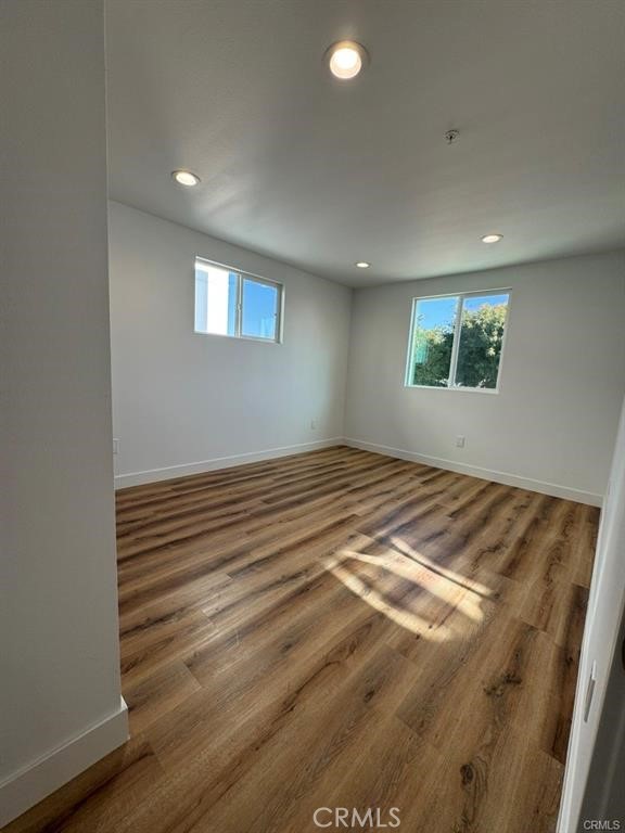 5875 San Pedro Street Los Angeles, CA 90003 - Photo 14 of 17 an empty room with wooden floor and windows