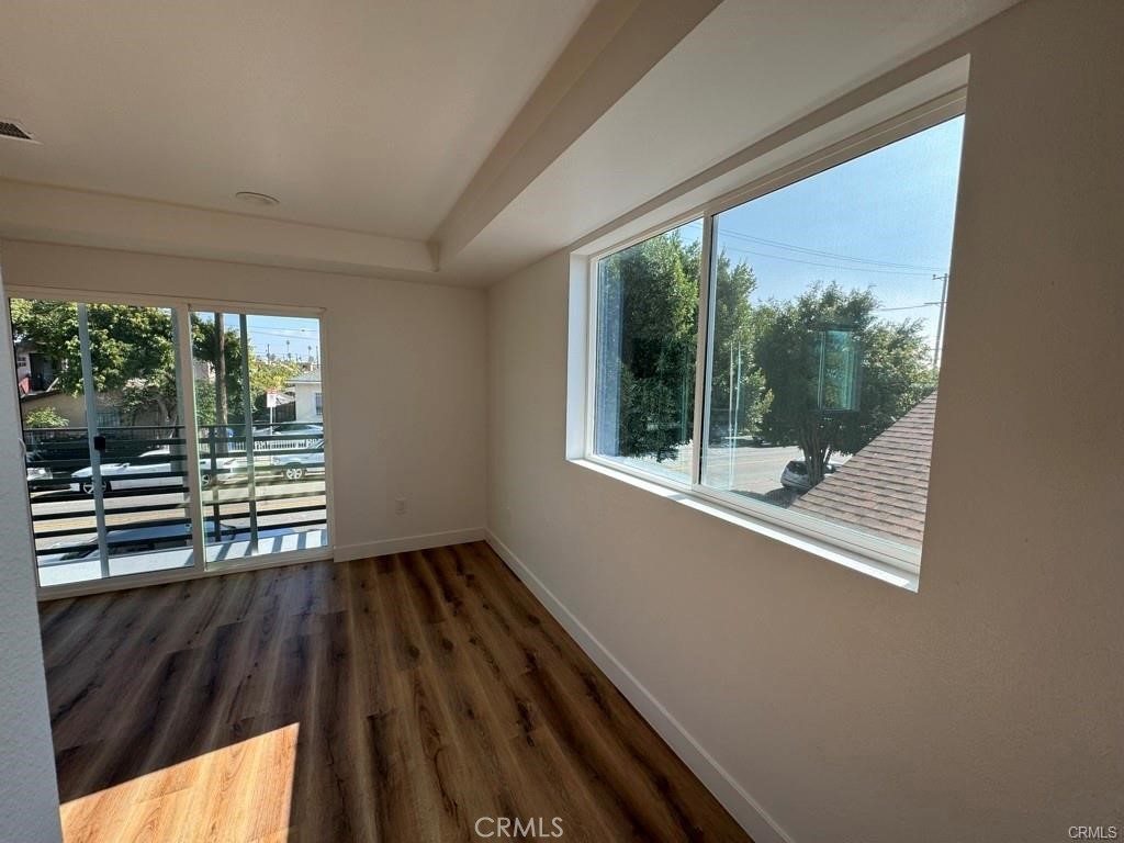 5875 San Pedro Street Los Angeles, CA 90003 - Photo 6 of 17 a view of a room with wooden floor and a window