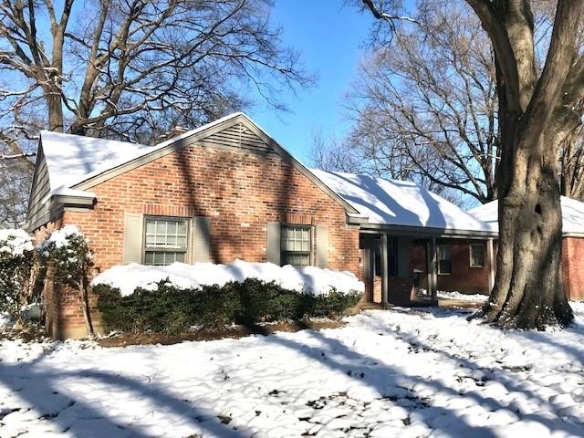 1633 Ivy Road Memphis, TN 38117 - Photo 1 of 14 a view of a house with snow on the road