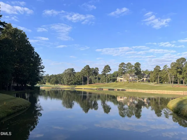 a view of a lake with houses in the background