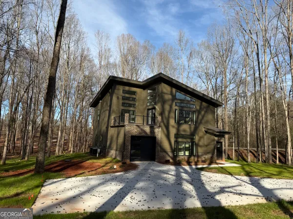 a view of a house with yard and utility room