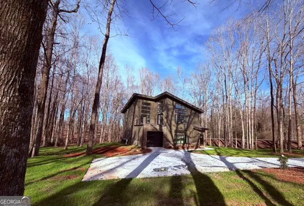 a view of a wooden house with a yard