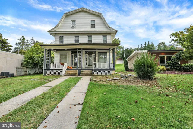 a view of a house with yard and a garden