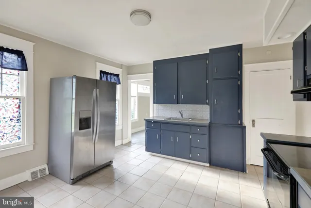 a kitchen with stainless steel appliances granite countertop a refrigerator and a stove
