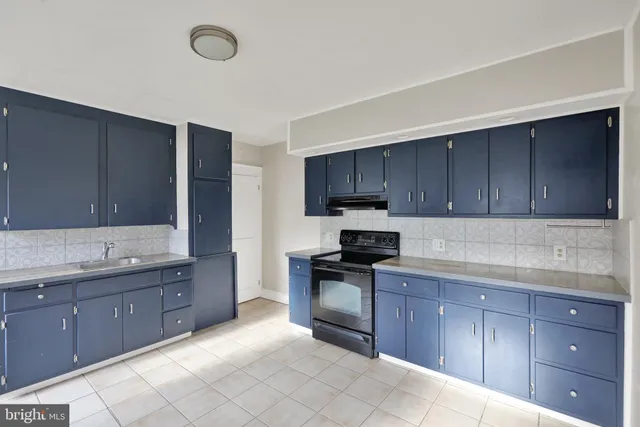 a kitchen with stainless steel appliances granite countertop a sink and cabinets