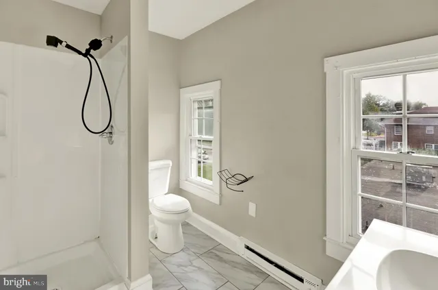 a bathroom with a toilet and a shower