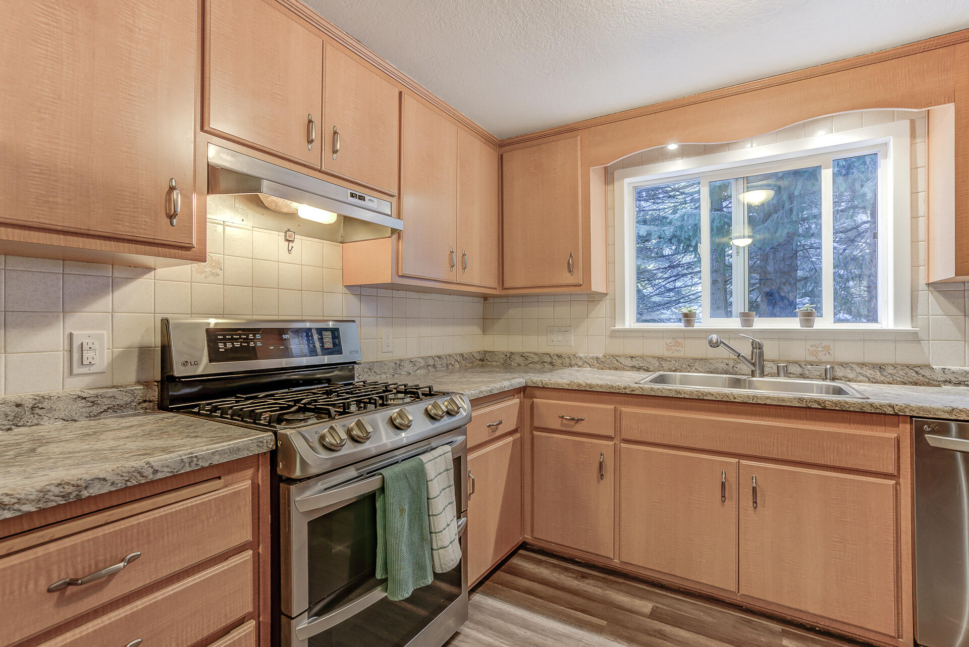 9390 Thatcher Mill Road Shingletown, CA 96088 - Photo 12 of 39 a kitchen with granite countertop white cabinets and a stove top oven