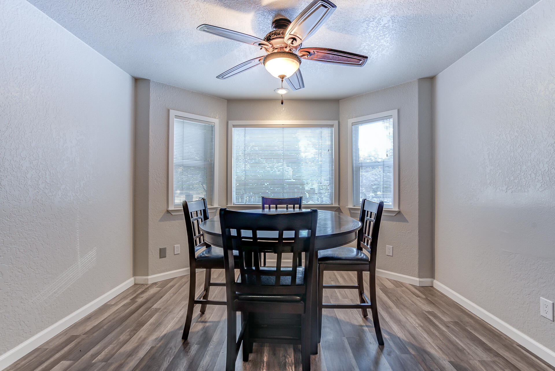 9390 Thatcher Mill Road Shingletown, CA 96088 - Photo 6 of 39 a view of a dining room with furniture window and wooden floor