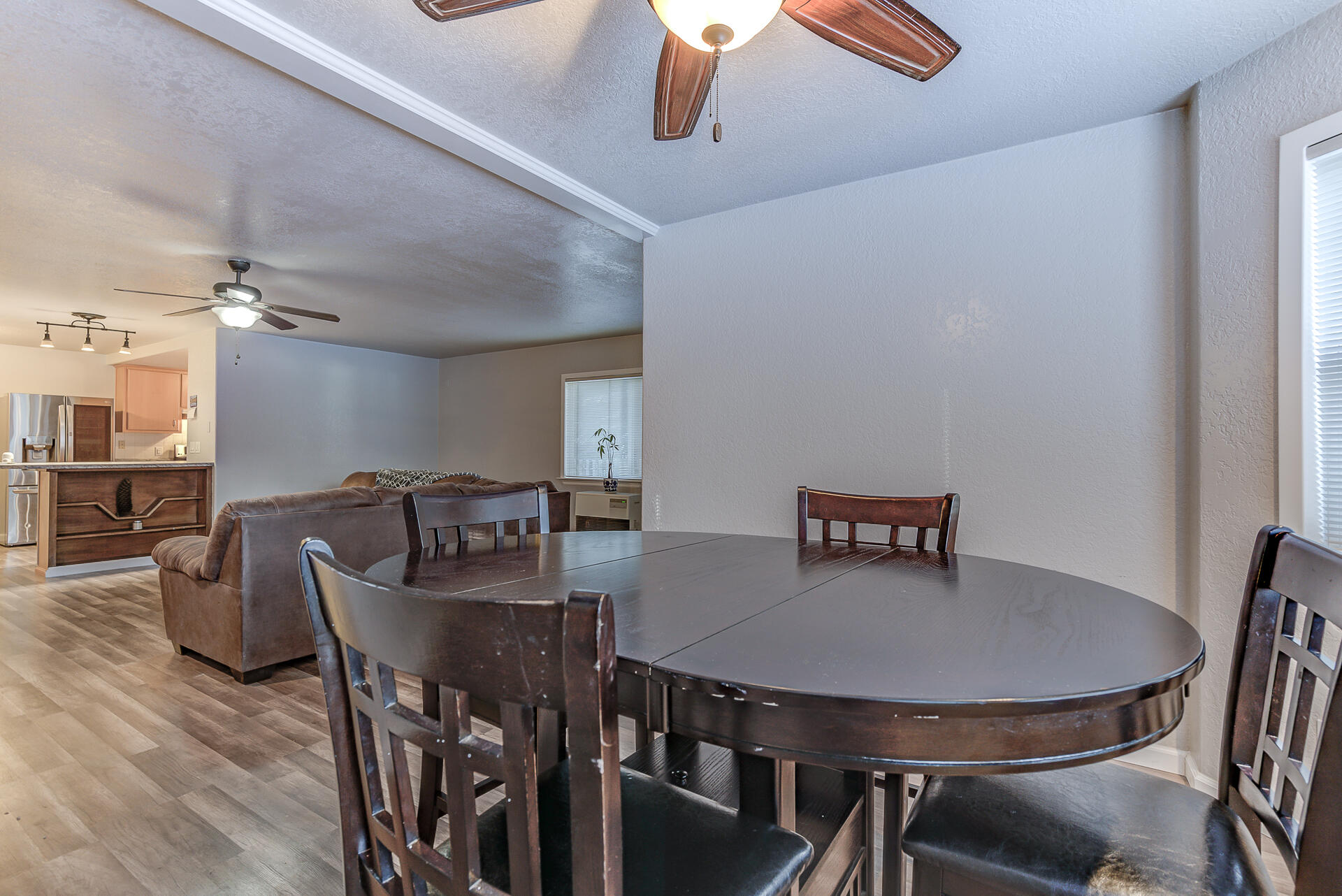 9390 Thatcher Mill Road Shingletown, CA 96088 - Photo 8 of 39 a view of a dining room with furniture and wooden floor