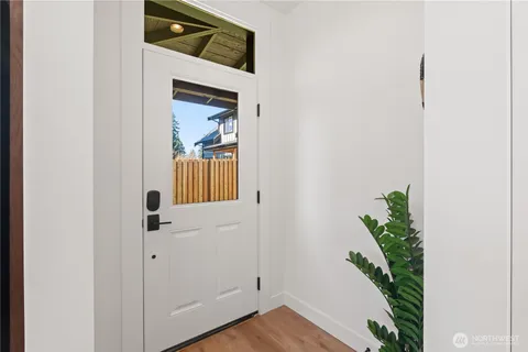 a view of an entryway and wooden floor