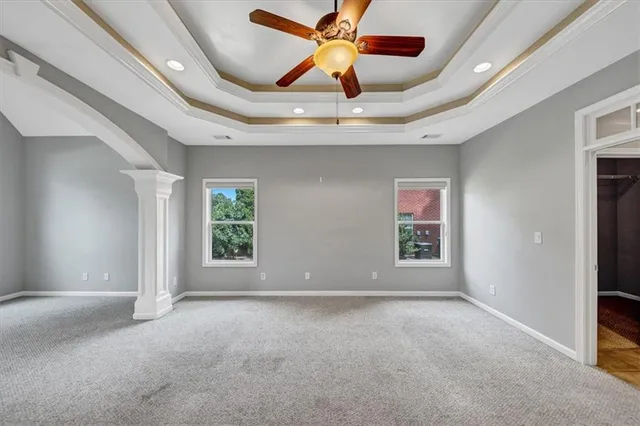 a spacious bathroom with a granite countertop sink a mirror and a bathtub