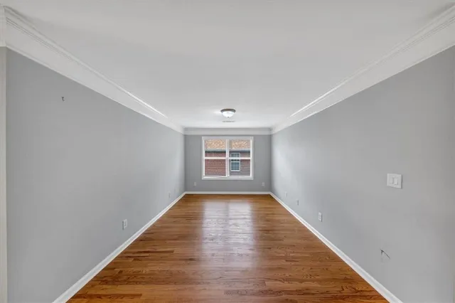 an empty room with closet and a ceiling fan