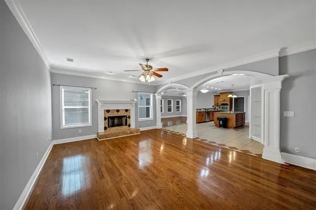 a view of a kitchen with kitchen island granite countertop a refrigerator and a stove top oven