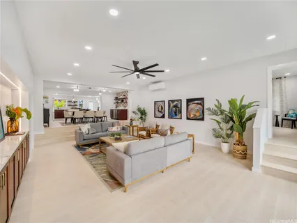 a living room with furniture and a potted plant