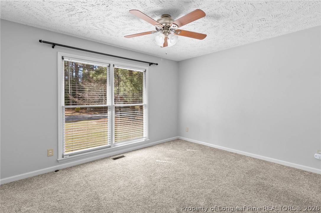 7756 Dragonhead Road Fayetteville, NC 28311 - Photo 24 of 42 an empty room with windows and fan