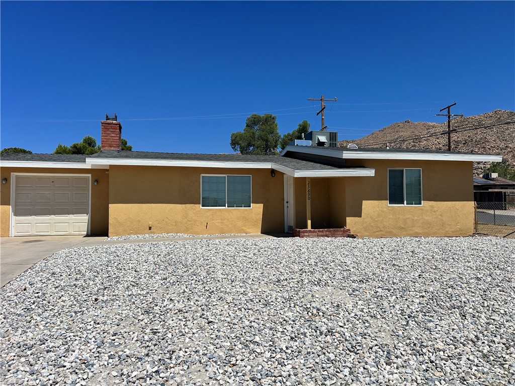 23890 Tocaloma Road Apple Valley, CA 92307 - Photo 1 of 1 a front view of a house with a yard