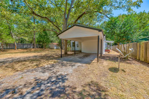 a backyard of a house with table and chairs