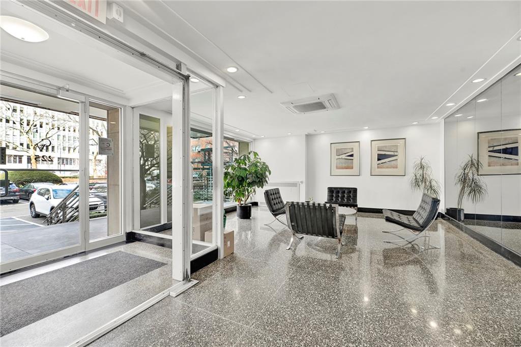 225 Adams Street, Unit 4E Brooklyn, NY 11201 - Photo 2 of 15 a living room with furniture large window and wooden floor