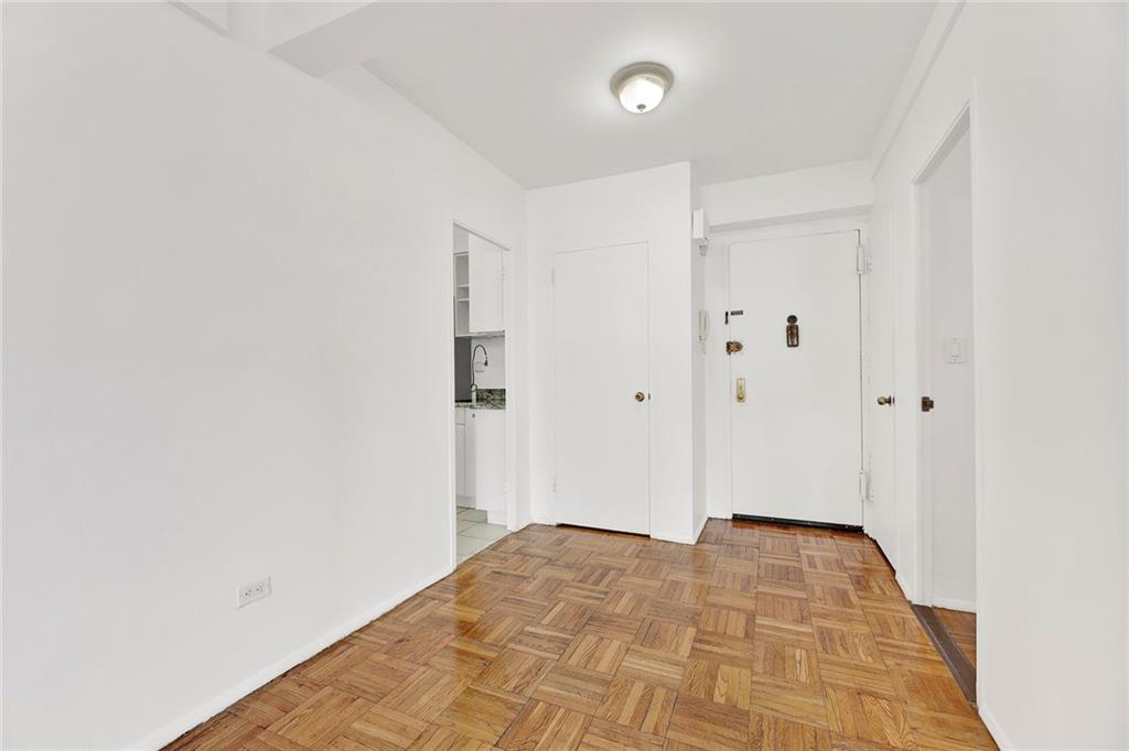 225 Adams Street, Unit 4E Brooklyn, NY 11201 - Photo 4 of 15 a view of a room with wooden floor and white walls
