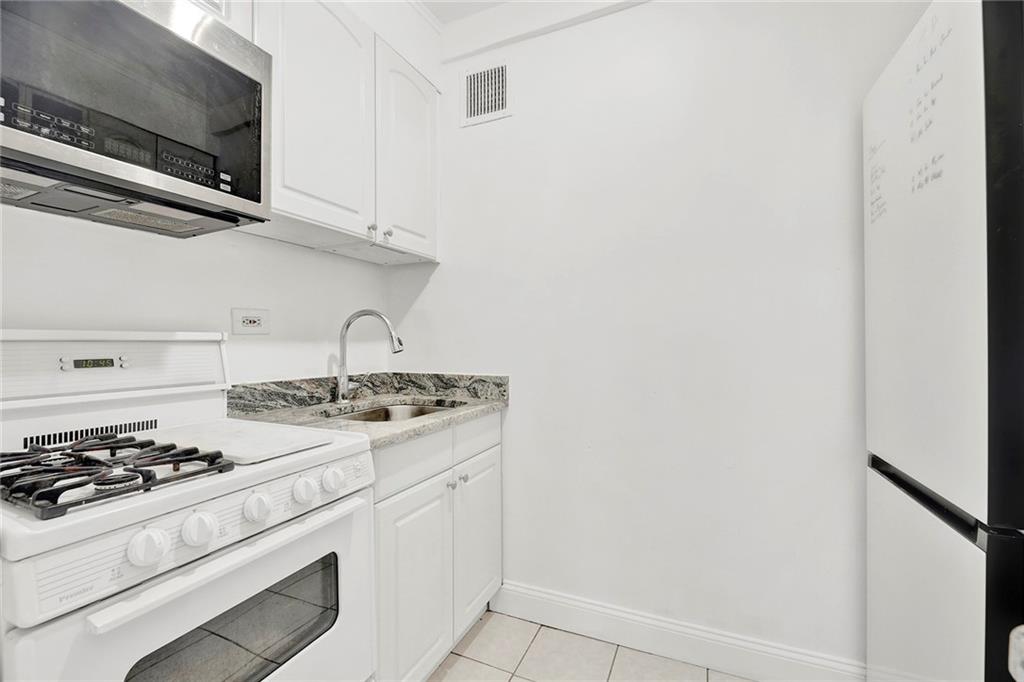 225 Adams Street, Unit 4E Brooklyn, NY 11201 - Photo 6 of 15 a white stove top oven sitting inside of a kitchen