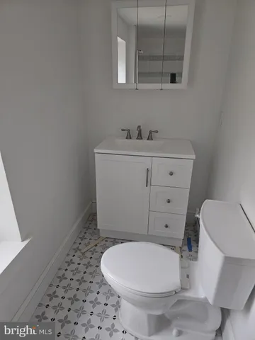 a bathroom with a sink toilet and mirror