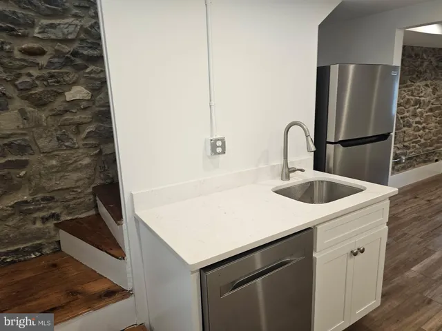 a kitchen with a sink and a refrigerator