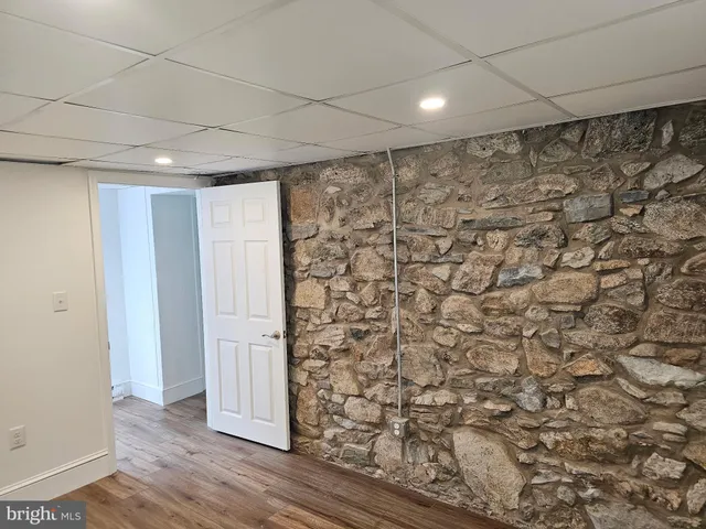 a view of a livingroom with wooden floor and a window