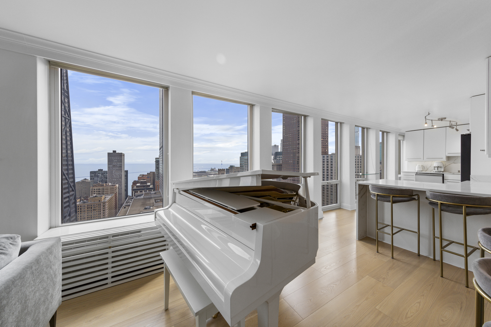 111 East Chestnut Street, Unit 38C Chicago, IL 60611 - Photo 15 of 39 a kitchen with granite countertop a stove a sink and a refrigerator