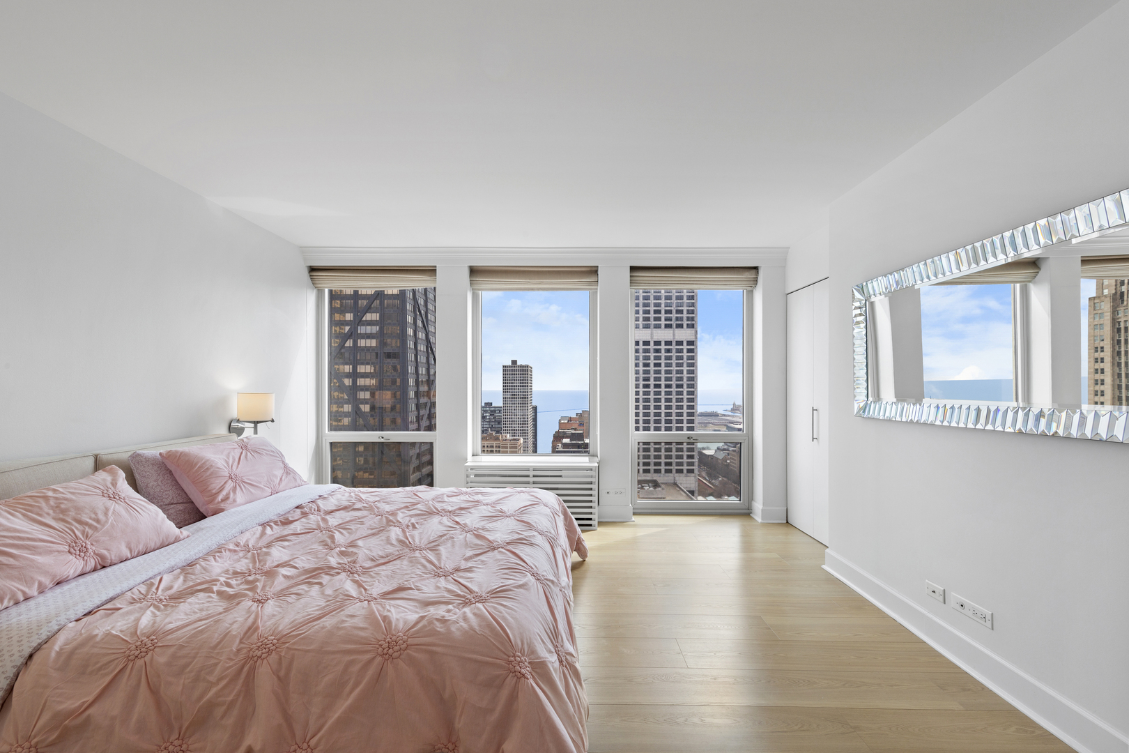 111 East Chestnut Street, Unit 38C Chicago, IL 60611 - Photo 16 of 39 a bedroom with a large bed and a large window