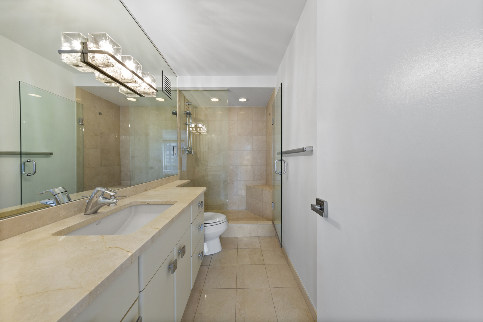 111 East Chestnut Street, Unit 38C Chicago, IL 60611 - Photo 20 of 39 a bathroom with a double vanity sink toilet and shower