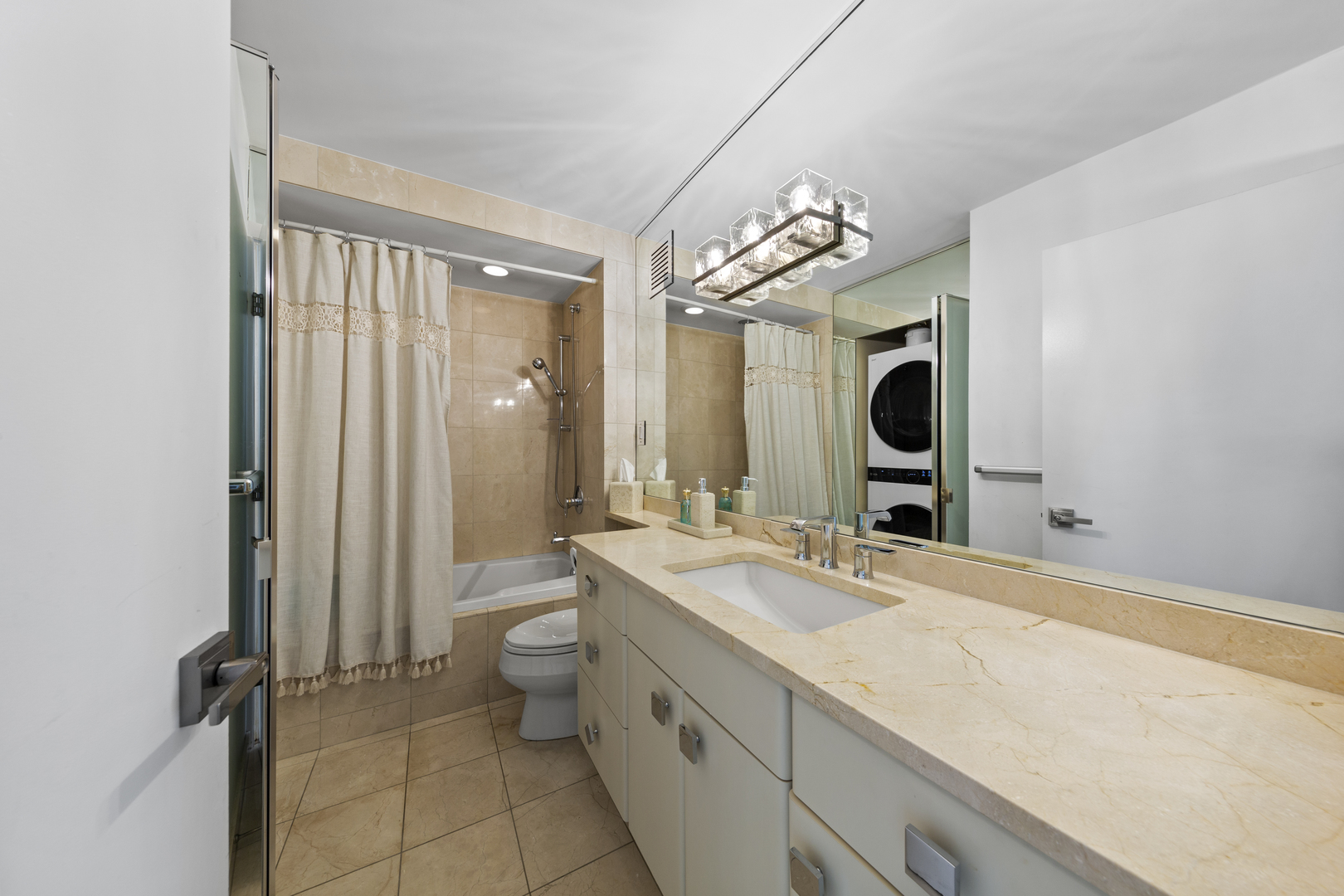 111 East Chestnut Street, Unit 38C Chicago, IL 60611 - Photo 21 of 39 a spacious bathroom with a granite countertop sink mirror and toilet