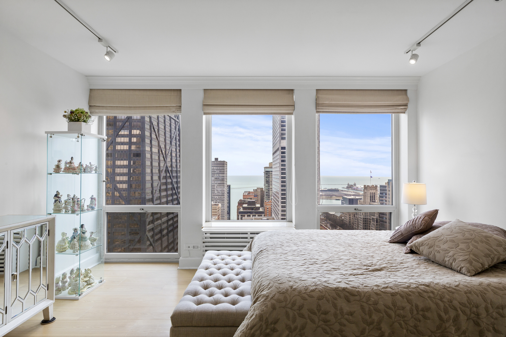 111 East Chestnut Street, Unit 38C Chicago, IL 60611 - Photo 22 of 39 a bedroom with a bed and glass window