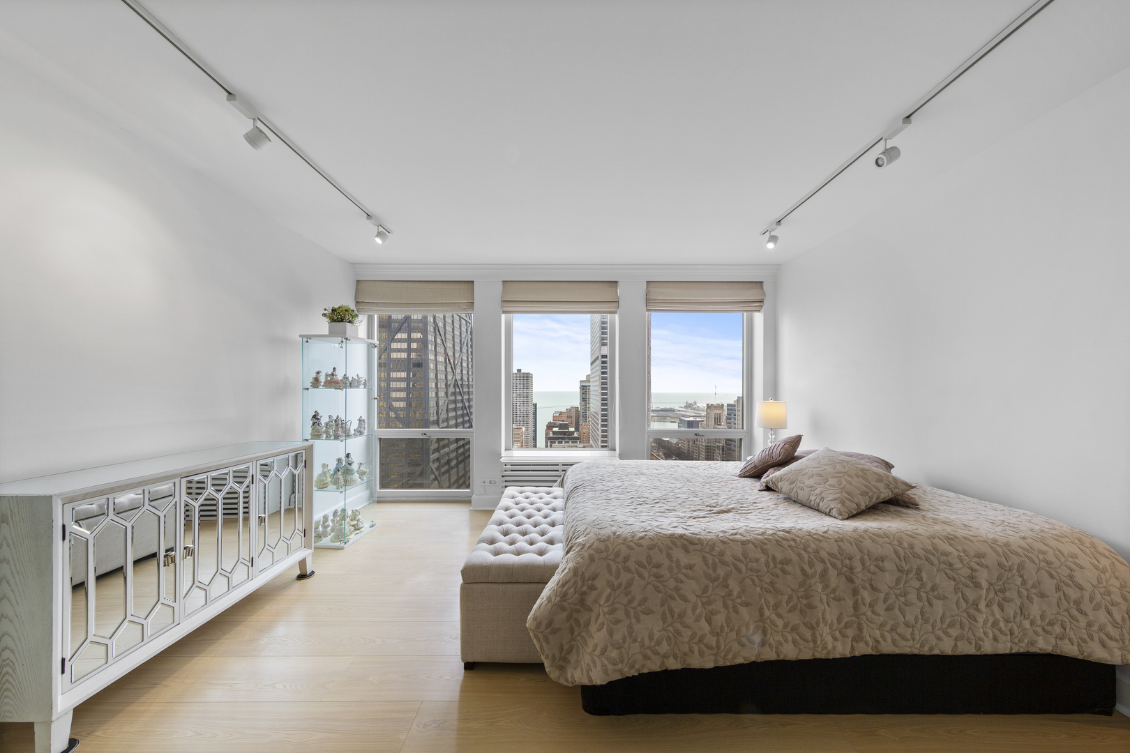 111 East Chestnut Street, Unit 38C Chicago, IL 60611 - Photo 23 of 39 a bedroom with a bed and a large window