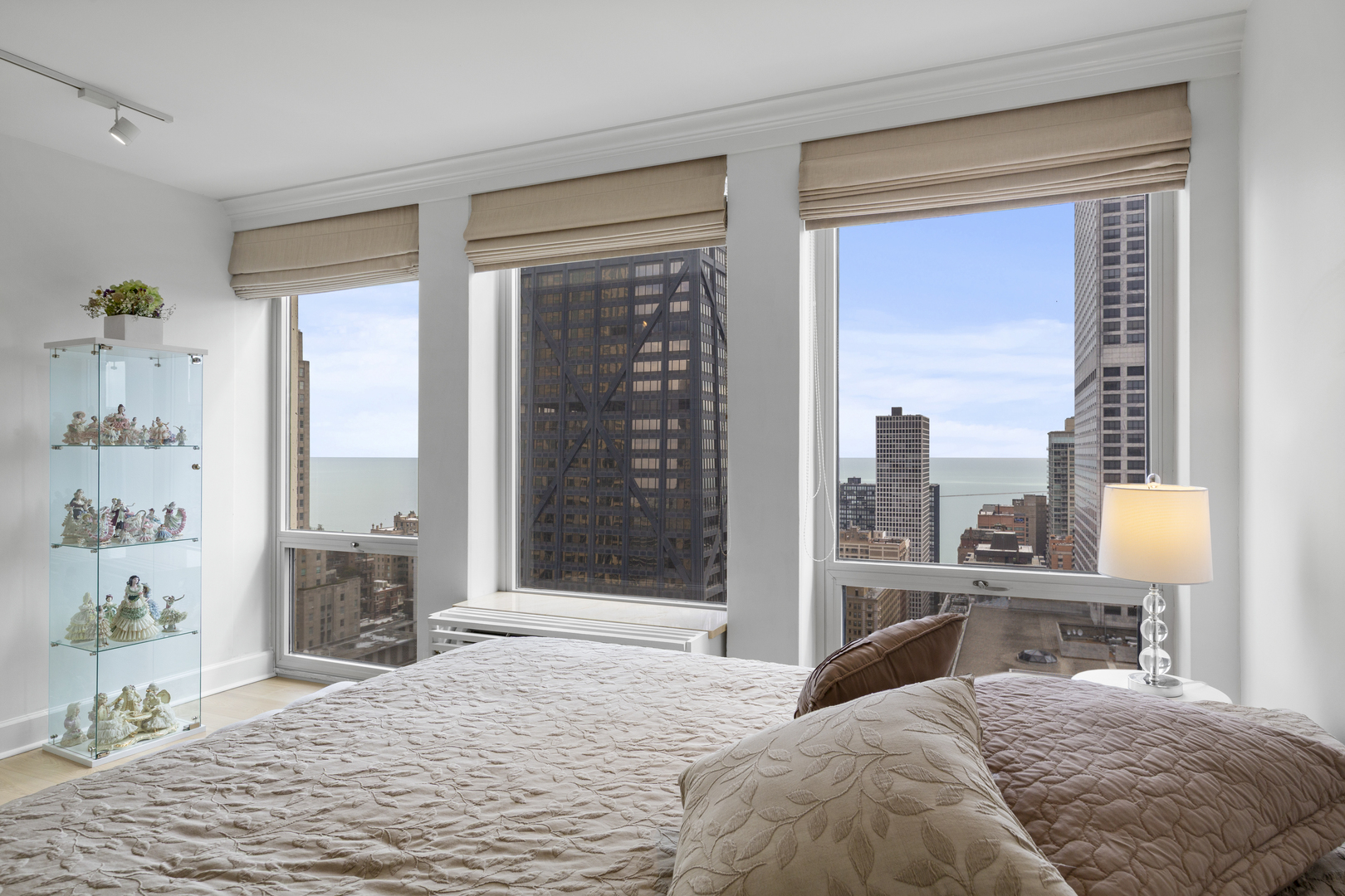 111 East Chestnut Street, Unit 38C Chicago, IL 60611 - Photo 25 of 39 a bedroom with a large bed and a large window
