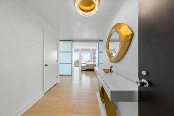 a bedroom with a bed and a wooden floor