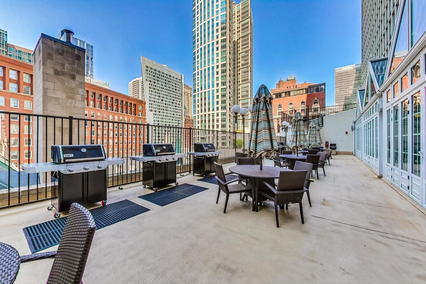 111 East Chestnut Street, Unit 38C Chicago, IL 60611 - Photo 31 of 39 a view of a patio with a table and chairs